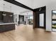Open-concept living room with hardwood floors, modern lighting, and a view to the outside at 5258 Lions Paw St, Castle Rock, CO 80104
