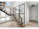 Bright foyer with modern staircase design featuring wood treads, metal railings, and a large window at 5258 Lions Paw St, Castle Rock, CO 80104