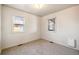 A bright bedroom featuring neutral carpet, white walls, and natural light from two windows at 4100 Fenton St, Denver, CO 80212