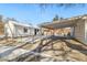 A long driveway with a covered carport next to the home with wintery landscape at 4100 Fenton St, Denver, CO 80212