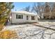 Charming home featuring a quaint front exterior with a walkway and snowy yard at 4100 Fenton St, Denver, CO 80212