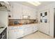 Charming kitchen with white cabinetry, light countertops and tiled flooring at 4100 Fenton St, Denver, CO 80212