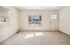 Bright living room featuring neutral carpet, large window, and a white front door at 4100 Fenton St, Denver, CO 80212