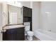Cozy bathroom boasts a vanity with storage, toilet, and a bathtub with tiled walls at 16285 W 62Nd Ln # C, Arvada, CO 80403