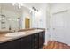Bathroom featuring a double sink vanity and a glass-enclosed shower at 16285 W 62Nd Ln # C, Arvada, CO 80403