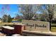 The Boyd Ponds community sign is set amongst beautiful landscaping with a lake view at 16285 W 62Nd Ln # C, Arvada, CO 80403