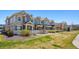 Row of townhomes boasts manicured lawn and tidy landscaping for prime curb appeal at 16285 W 62Nd Ln # C, Arvada, CO 80403
