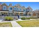 Attractive townhome complex with manicured lawns, white picket fences, and inviting front entrances at 16285 W 62Nd Ln # C, Arvada, CO 80403