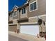 Exterior view of townhome featuring two-car garages and neutral-colored siding at 16285 W 62Nd Ln # C, Arvada, CO 80403