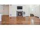 Inviting living room featuring hardwood floors and a modern fireplace at 16285 W 62Nd Ln # C, Arvada, CO 80403