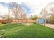 Well-maintained backyard with lush green grass, wooden privacy fence, and a charming shed adding character at 1662 S Eudora St, Denver, CO 80222