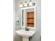 Traditional pedestal sink, a decorative mirror, and classic finishes complement this charming bathroom at 1662 S Eudora St, Denver, CO 80222