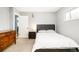 Cozy bedroom featuring neutral walls and carpet, with an inviting bed and doorway to another room at 1662 S Eudora St, Denver, CO 80222