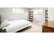 Bright bedroom featuring two windows, ladder shelves, neutral walls, and a minimalist aesthetic at 1662 S Eudora St, Denver, CO 80222