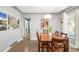 Bright dining room with hardwood floors, featuring a wooden dining table and view to other rooms at 1662 S Eudora St, Denver, CO 80222
