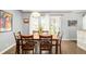 Elegant dining room featuring a wooden table with seating for six and large windows for natural light at 1662 S Eudora St, Denver, CO 80222