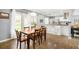 Cozy dining area adjacent to the kitchen with hardwood floors and views of the backyard at 1662 S Eudora St, Denver, CO 80222