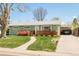 Inviting ranch-style home with a covered carport and beautifully landscaped front yard on a sunny day at 1662 S Eudora St, Denver, CO 80222