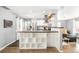 Modern kitchen with white cabinets, stainless steel appliances, and a breakfast bar open to the living area at 1662 S Eudora St, Denver, CO 80222
