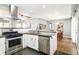 Well-lit kitchen featuring stainless steel appliances, stylish black countertops, and modern white cabinets at 1662 S Eudora St, Denver, CO 80222