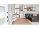 Open-concept living room with hardwood floors and access to the dining area and backyard at 1662 S Eudora St, Denver, CO 80222