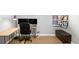 Home office with desk, dual monitors, storage bench, hardwood floors, and contemporary style at 1662 S Eudora St, Denver, CO 80222