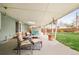 Outdoor covered patio with cozy seating offers an ideal spot for relaxation and casual entertaining at 1662 S Eudora St, Denver, CO 80222