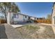 Large backyard with gravel and grass areas, patio, and wood fence at 2448 S Galapago St, Denver, CO 80223