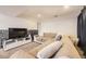 Comfortable basement living room with a TV and neutral-toned sectional couch at 2448 S Galapago St, Denver, CO 80223