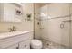 Modern bathroom featuring tiled walls, a glass-enclosed shower, and updated vanity at 2448 S Galapago St, Denver, CO 80223