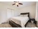 Comfortable bedroom featuring a ceiling fan, a closet, and a large window with natural light at 2448 S Galapago St, Denver, CO 80223