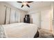 Comfortable bedroom featuring a ceiling fan, a closet, and a large window with natural light at 2448 S Galapago St, Denver, CO 80223