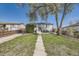 Charming home featuring a well-maintained front yard with mature tree and concrete walkway at 2448 S Galapago St, Denver, CO 80223