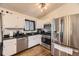 Functional kitchen with stainless steel appliances, black countertops, and ample cabinet space at 2448 S Galapago St, Denver, CO 80223