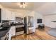 Kitchen with stainless steel appliances including refrigerator and oven stove, and breakfast bar at 2448 S Galapago St, Denver, CO 80223