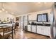 Open kitchen featuring modern appliances, bar seating, and hardwood floors at 2448 S Galapago St, Denver, CO 80223