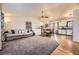 Spacious living room featuring open floorplan, a breakfast bar, and hardwood floors at 2448 S Galapago St, Denver, CO 80223