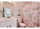 A well-lit bathroom featuring a white vanity, and a shower with a decorative leaf-patterned curtain at 24374 E 42Nd Ave, Aurora, CO 80019