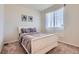 Serene bedroom with soft carpet, a sleigh bed, and a large window that brings in ample light at 24374 E 42Nd Ave, Aurora, CO 80019