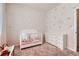 A well-designed Bedroom showcasing a white crib, dresser, and soft carpet for a cozy atmosphere at 24374 E 42Nd Ave, Aurora, CO 80019