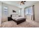 Cozy bedroom with plush carpet, neutral paint, a ceiling fan, and large windows offering natural light at 24374 E 42Nd Ave, Aurora, CO 80019