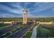 Grand entrance featuring a clock tower and stone accents welcomes residents to The Aurora Highlands community at 24374 E 42Nd Ave, Aurora, CO 80019
