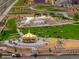 Aerial view of a vibrant community park with a carousel, event space, and open green areas at 24374 E 42Nd Ave, Aurora, CO 80019