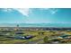 Scenic community view showcasing bridge, walking paths, clock tower, and stunning mountain backdrop at 24374 E 42Nd Ave, Aurora, CO 80019