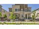 Modern townhome featuring a brick facade, landscaped front yard, and inviting front porch at 24374 E 42Nd Ave, Aurora, CO 80019