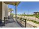 Relaxing front porch with black metal railing offering a view of the neighborhood and street at 24374 E 42Nd Ave, Aurora, CO 80019