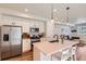 Stylish kitchen with stainless steel appliances, quartz countertops, and a large island at 24374 E 42Nd Ave, Aurora, CO 80019