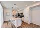 Bright kitchen featuring stainless steel appliances, white cabinetry, and a center island with pendant lighting at 24374 E 42Nd Ave, Aurora, CO 80019