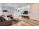 Cozy living area featuring a comfortable couch, large TV, and natural light at 24374 E 42Nd Ave, Aurora, CO 80019