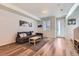 Comfortable living room with modern decor, a plush sofa, and wood-look flooring at 24374 E 42Nd Ave, Aurora, CO 80019